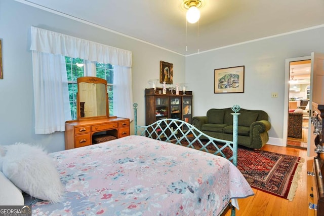 bedroom featuring crown molding and wood-type flooring