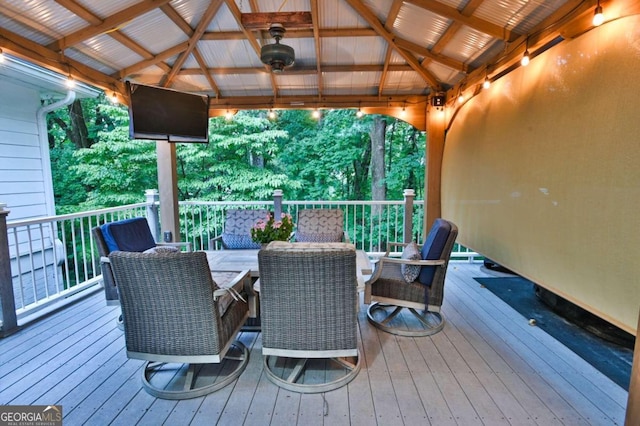 wooden terrace with a gazebo and a ceiling fan