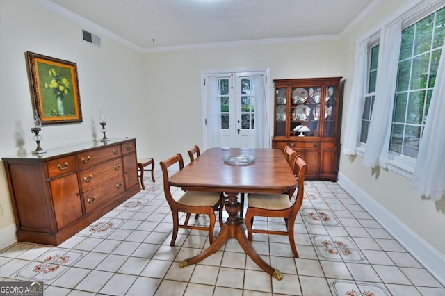 dining room with crown molding and light tile patterned flooring