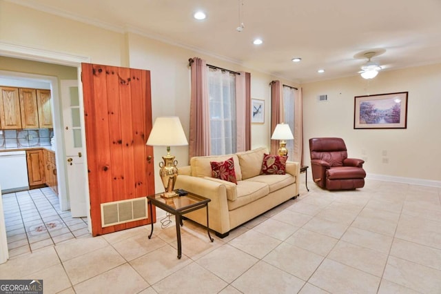 tiled living room with ceiling fan and crown molding