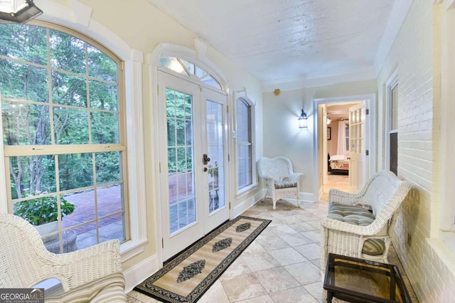 interior space with ornamental molding, french doors, baseboards, and light tile patterned floors