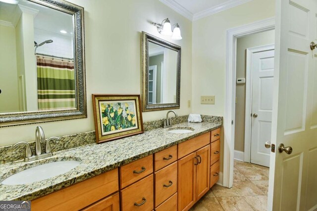 bathroom featuring ornamental molding, dual bowl vanity, and tile patterned floors