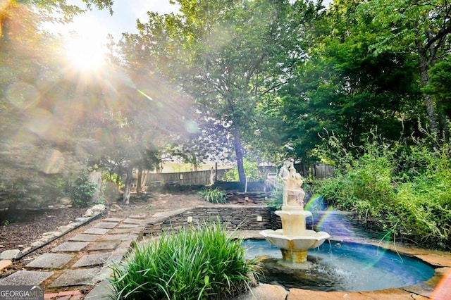 view of swimming pool with fence