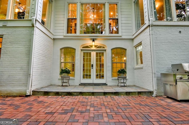 property entrance with a patio and french doors