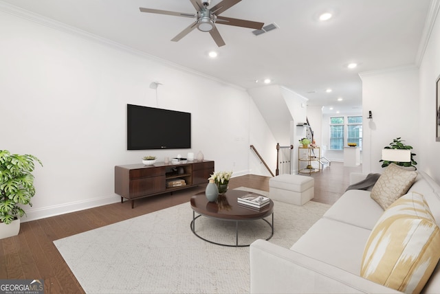 living room with ornamental molding, hardwood / wood-style flooring, and ceiling fan