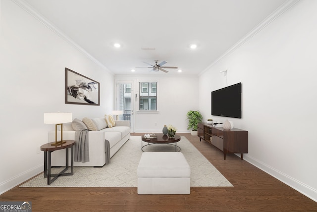 living room with crown molding, light wood-type flooring, and ceiling fan