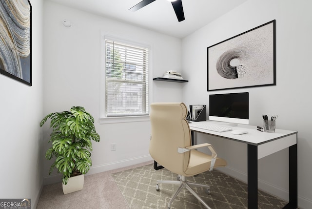 carpeted home office featuring ceiling fan