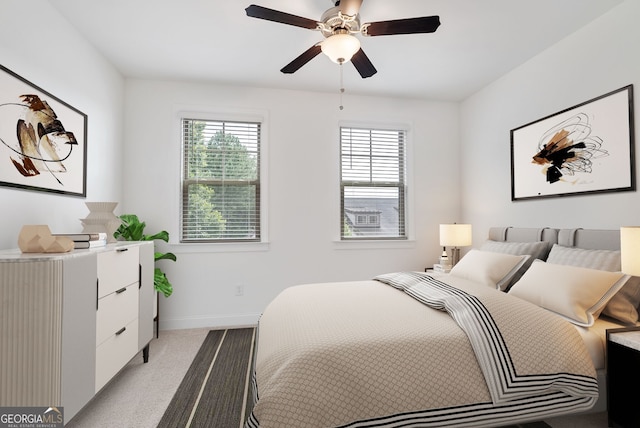 bedroom with light colored carpet and ceiling fan