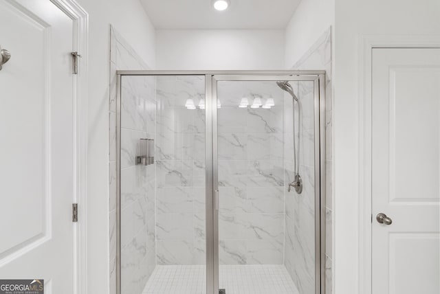 bathroom with a shower with door