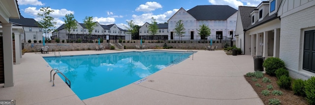 view of swimming pool featuring central air condition unit and a patio