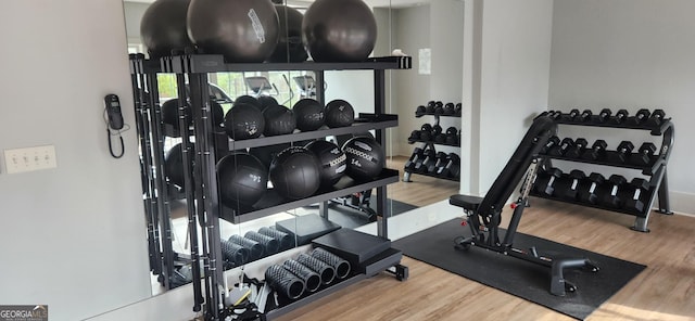 workout area with light hardwood / wood-style floors