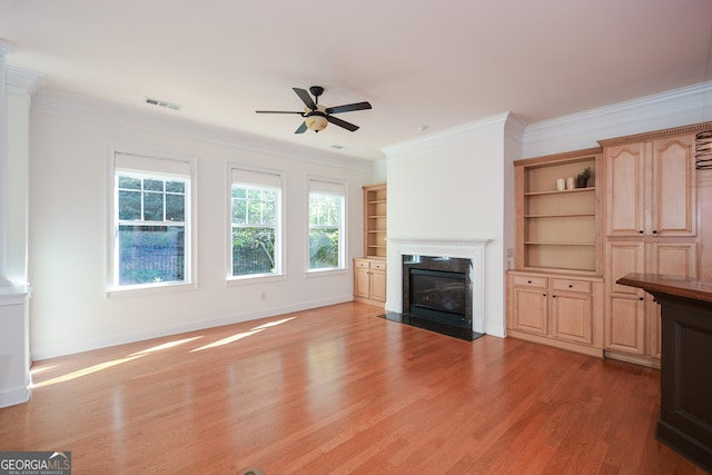 unfurnished living room featuring crown molding, light hardwood / wood-style flooring, and ceiling fan