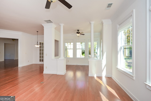 unfurnished living room featuring crown molding, light wood-type flooring, plenty of natural light, and ceiling fan