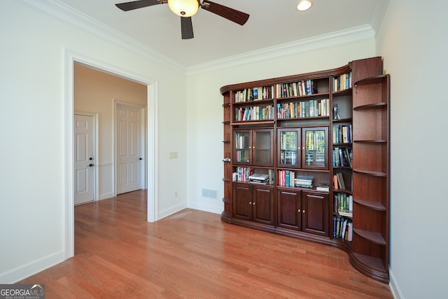 interior space featuring light hardwood / wood-style floors, crown molding, and ceiling fan