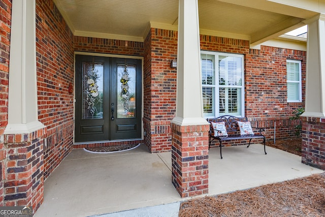 view of exterior entry with covered porch