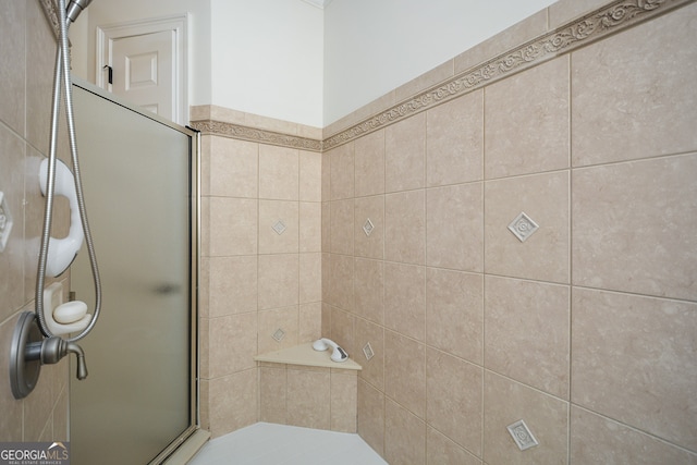 bathroom with a shower with door