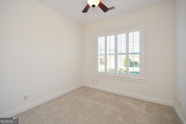 spare room with light carpet and plenty of natural light