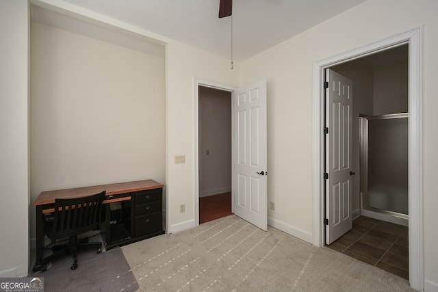 home office with light carpet and ceiling fan