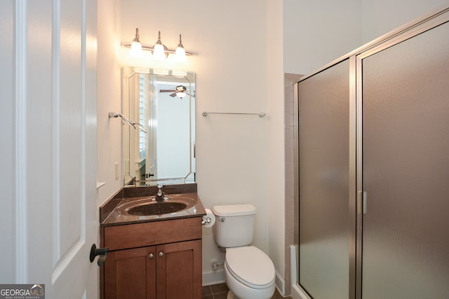 bathroom with ceiling fan, a shower with door, toilet, vanity, and tile patterned floors