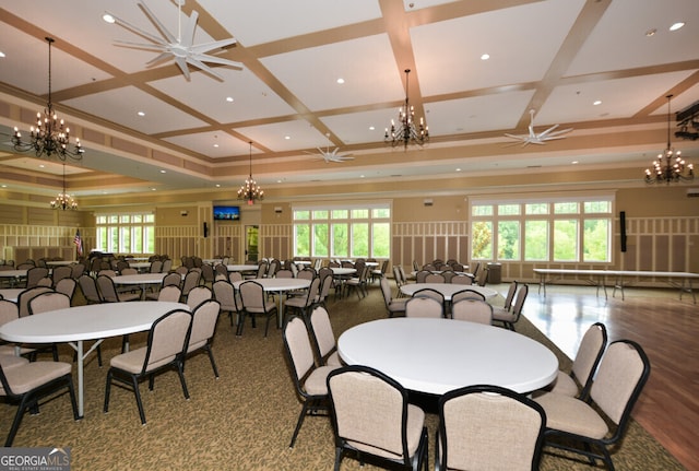 dining area with coffered ceiling, wood-type flooring, and a healthy amount of sunlight