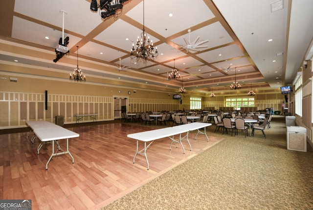 dining area featuring hardwood / wood-style floors, beamed ceiling, and coffered ceiling