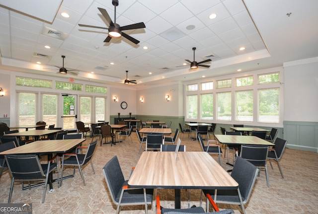 dining space featuring a healthy amount of sunlight and a raised ceiling