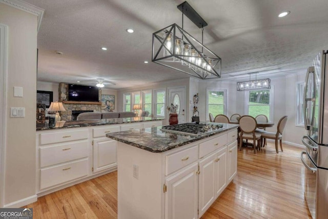 kitchen featuring white cabinetry, a textured ceiling, and a kitchen island