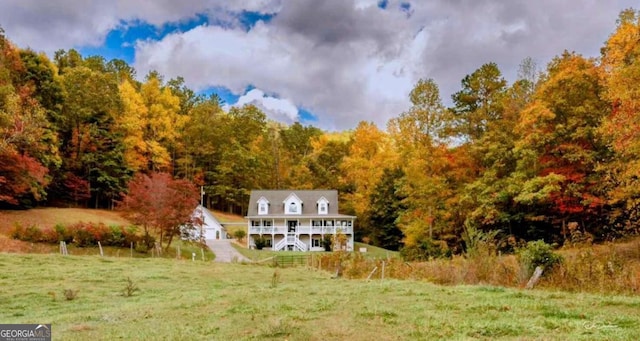 rear view of property featuring a yard