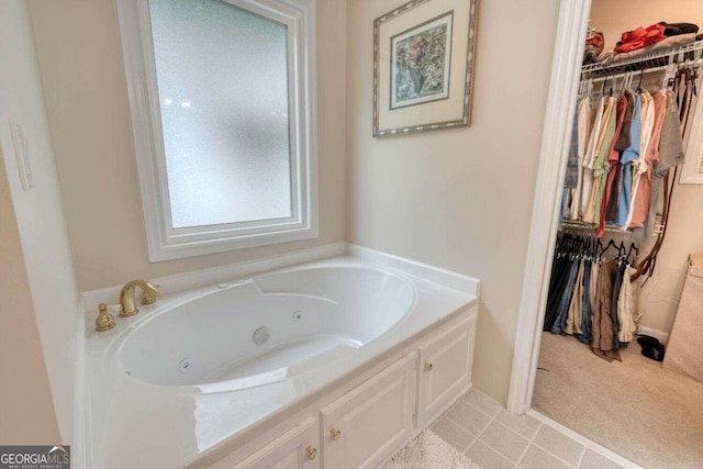 bathroom featuring tile patterned flooring and a bath