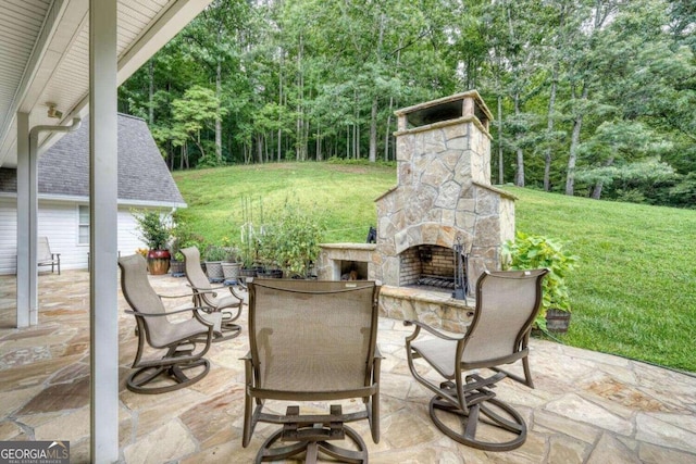 view of patio / terrace featuring an outdoor stone fireplace