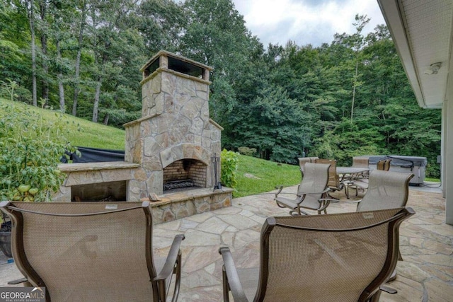 view of patio featuring an outdoor stone fireplace