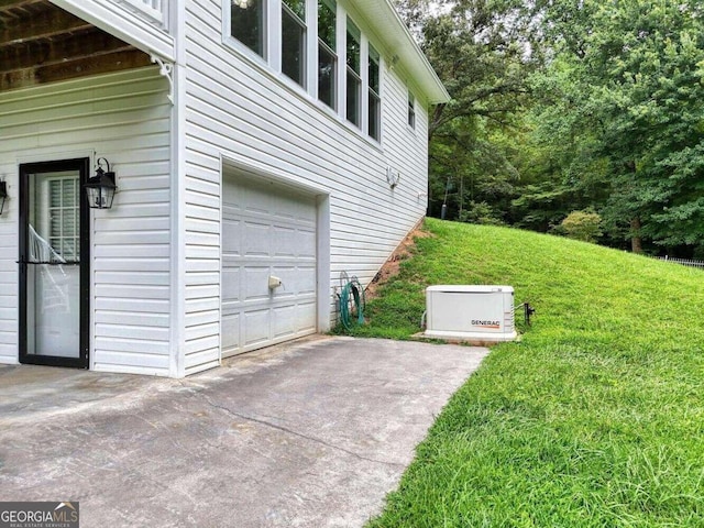 view of side of property with a garage and a lawn