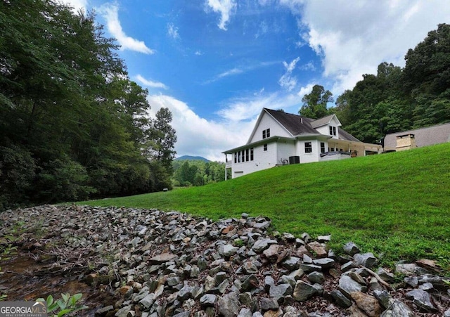 view of side of property with a yard