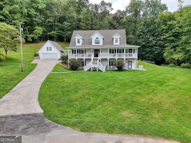 view of front facade featuring an outdoor structure, a garage, a porch, and a front lawn