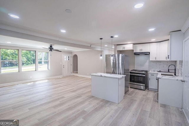 kitchen with white cabinetry, backsplash, stainless steel appliances, a center island, and decorative light fixtures