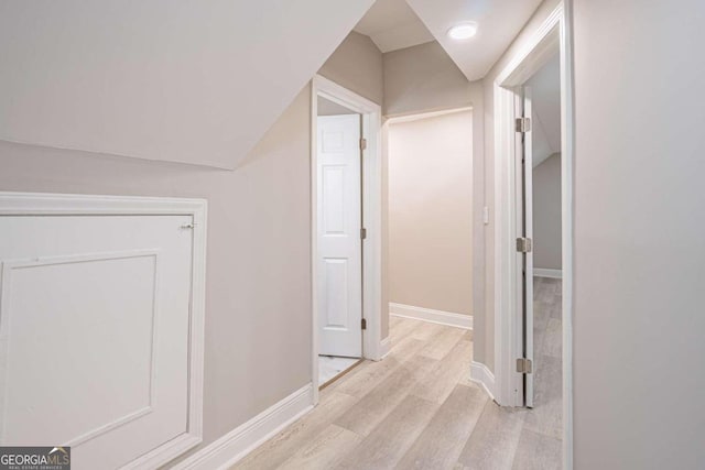 corridor with light hardwood / wood-style floors