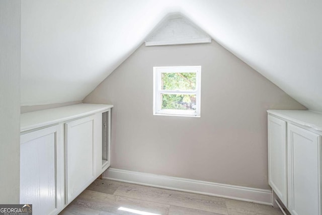 bonus room with lofted ceiling and light hardwood / wood-style flooring