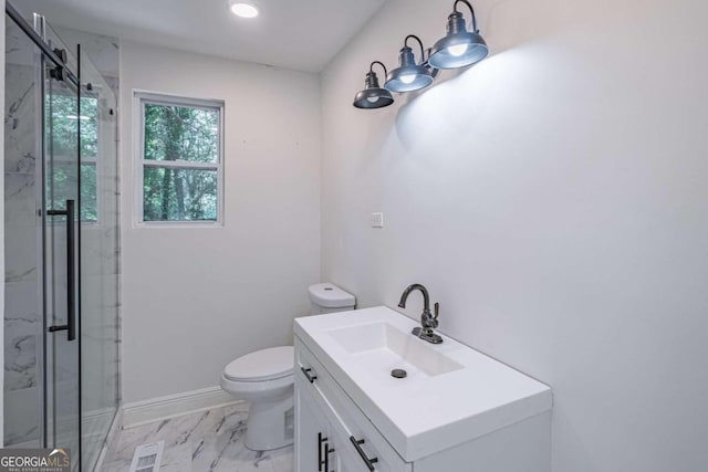 bathroom featuring vanity, an enclosed shower, and toilet