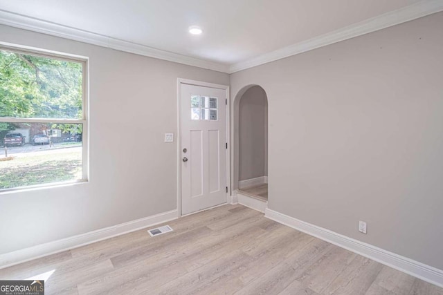 entryway featuring crown molding and light wood-type flooring