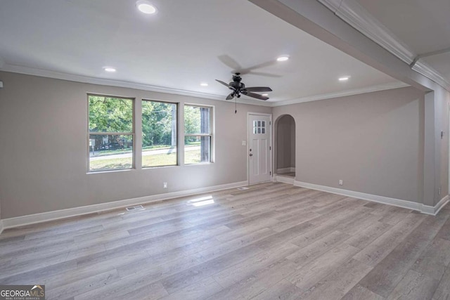 empty room with ornamental molding, ceiling fan, and light hardwood / wood-style floors