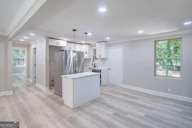 kitchen with pendant lighting, crown molding, tasteful backsplash, and white cabinets