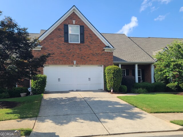 front facade featuring a garage and a front lawn