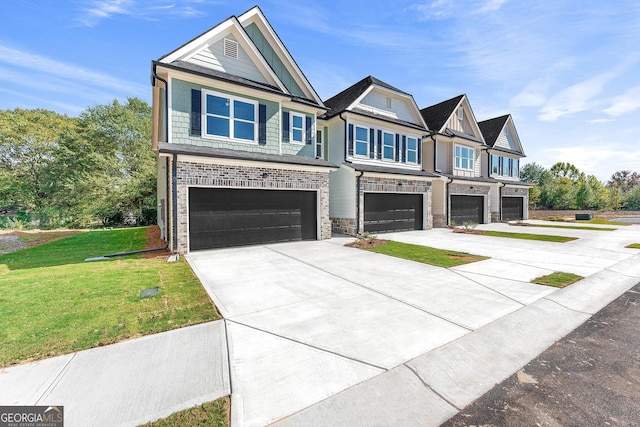 view of front of home featuring a front lawn, an attached garage, and driveway