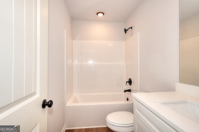 full bathroom featuring vanity, wood-type flooring, shower / washtub combination, and toilet