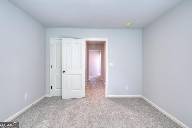 unfurnished bedroom featuring light carpet