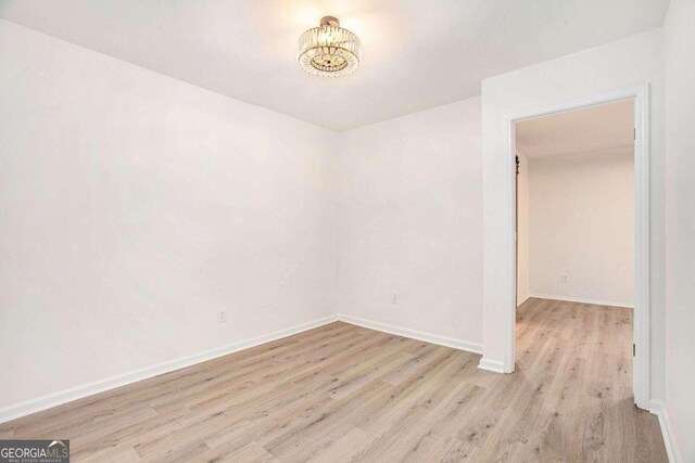 spare room with light hardwood / wood-style floors