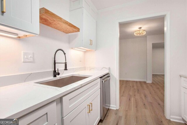 kitchen featuring white cabinetry, light hardwood / wood-style flooring, sink, and stainless steel dishwasher