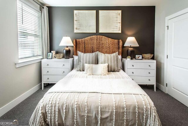 bedroom with dark colored carpet