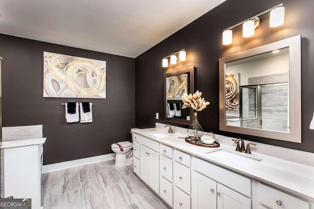 bathroom featuring dual vanity, toilet, and tile patterned floors