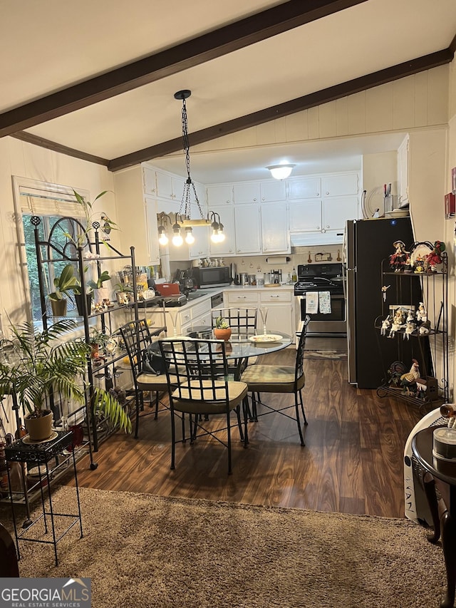 dining area featuring dark wood-type flooring, beam ceiling, and an inviting chandelier